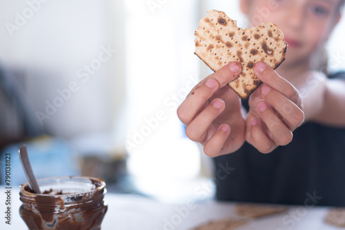 Children hands hold Matzah shape of heart. Traditional of Jewish Holiday on Passover. Home symbol of lovely family. top view, layout. love and care. Gift for lovers. big happy family in love