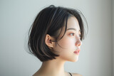 Side profile of a young Asian woman with short hair and natural light