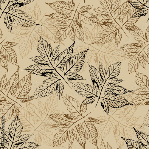 Seamless pattern with openwork silhouettes of maple leaves on a beige background. Black and brown prints of skeletonized leaves. For fabric, wrapping paper, cover, wrap.