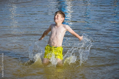 Young boy splashing in water