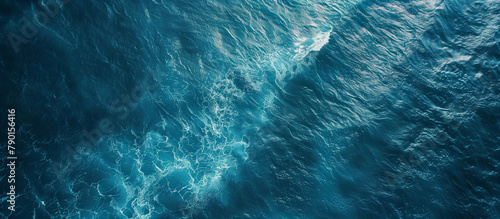 An aerial view of the open ocean, showing calm blue waters with subtle wave patterns, suitable for a peaceful background. , background photo