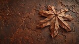 A close-up papercut of a single maple leaf, its edges tinged with brown, veins intricately detailed on the textured paper.
