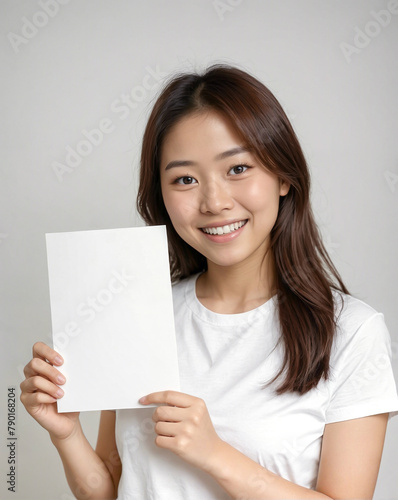 teenage woman holding a white paper