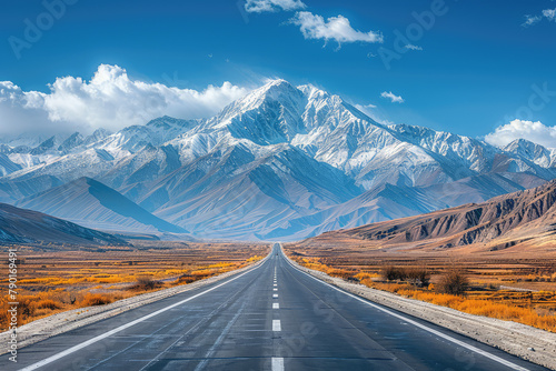  A yellow road line with snowcapped mountains in the background, in the style of high-definition photography. Created with Ai