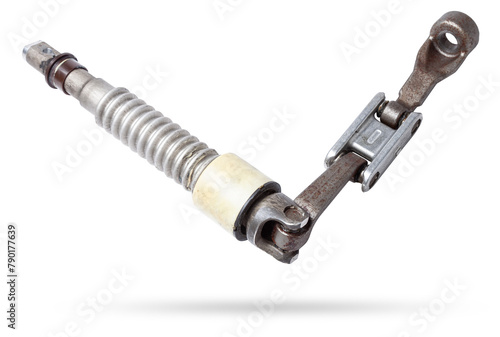 The spare part of the car is a metal steering propeller shaft with hinges on a white background with inscriptions designating the model. Repair of equipment at the auto-parsing in the workshop.