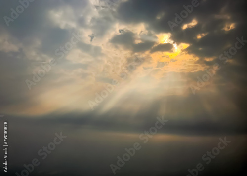 Background with copy space of sun rays through broken clouds over the ocean