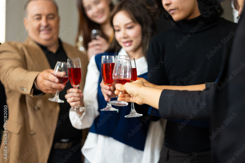 Closeup hand holding glassware. Business people celebrate making a toast on event party at office. Celebration Success Concept Closeup hand holding glassware. Business people celebrate making a toast on event party at office. Celebration Success Concept