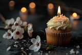 Single Lit Candle on a Birthday Cupcake Against a Sparkling Background