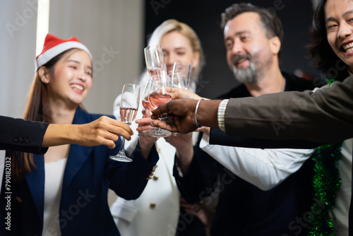 Closeup hand holding glassware. Business people celebrate making a toast on event party at office. Celebration Success Concept