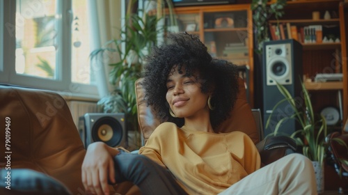 Woman enjoying hi fi music with modern audio speaker system in living room
