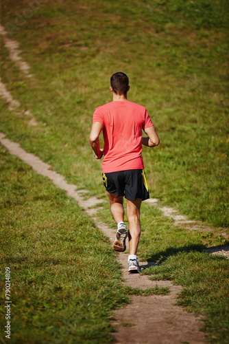 Sporty, man and jogging in outdoor for fitness, health and running in nature for workout or exercise. Male athlete, training and cardio with endurance, muscles and strength for healthy living or gym