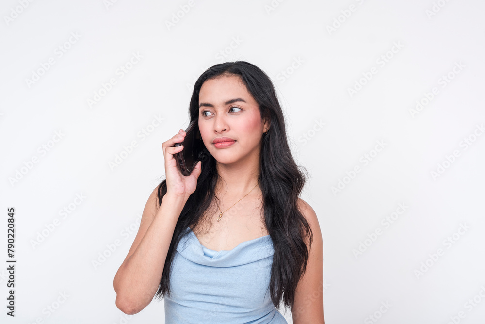 Young woman in a baby blue dress making a phone call isolated on white Young woman in a baby blue dress making a phone call isolated on white