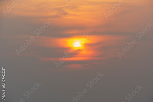 Evening sky time with sun and orange clouds in sunset sky background.Heat wave hot sun, climate change and global warming concept.