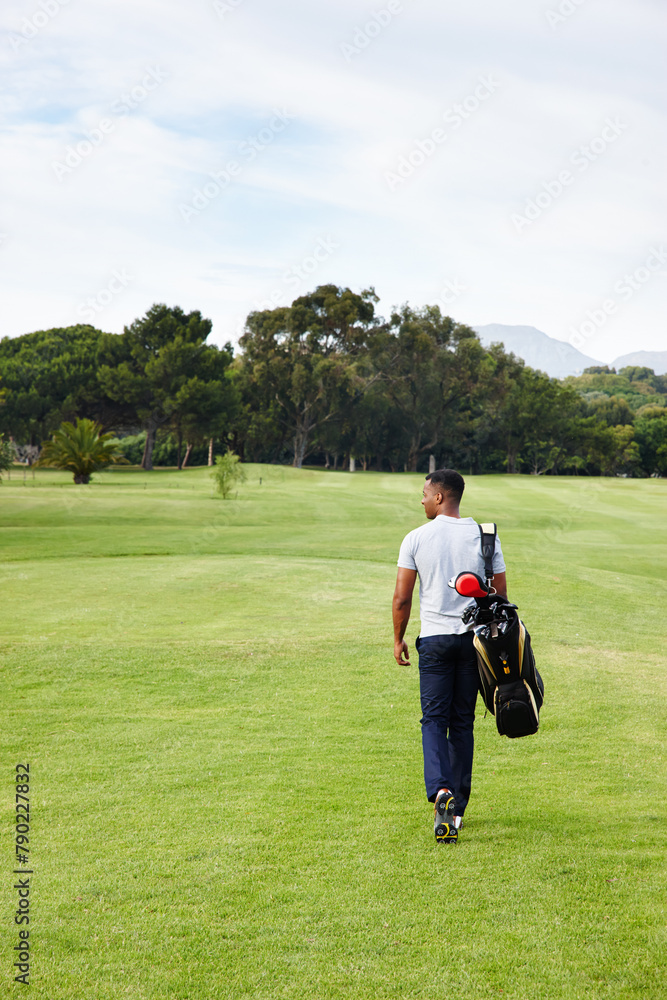 Sports, man and walking on golf course with bag or athlete outdoor on luxury holiday or vacation. Grass, field and exercise in summer on lawn with person in countryside for training or workout Sports, man and walking on golf course with bag or athlete outdoor on luxury holiday or vacation. Grass, field and exercise in summer on lawn with person in countryside for training or workout