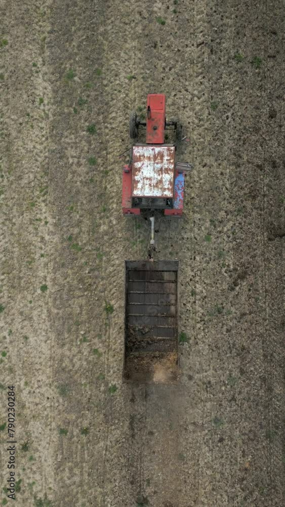Top view of tractor fertilizing farm field Top view of tractor fertilizing farm field