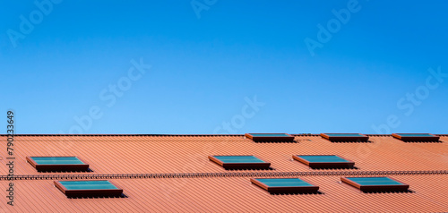 Metal roof of a commercial building with skylights  under a clear blue sky in Boston  Massachusetts  USA 