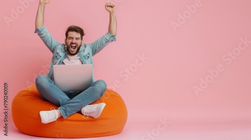 Man Celebrating Success with Laptop photo