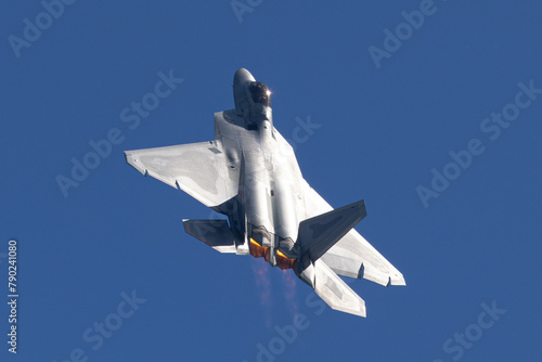 Top view of a F-22 Raptor in beautiful light, with afterburners on
