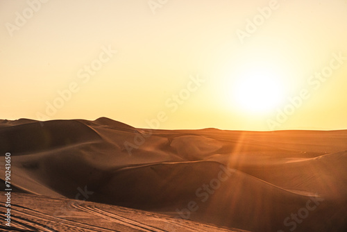 sunset over the dunes in the desert in huacachina