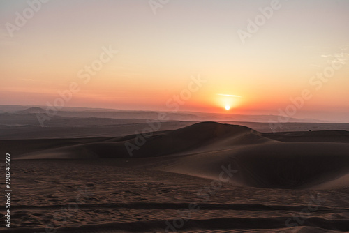 Fototapeta Naklejka Na Ścianę i Meble -  sunset over the dunes in the desert in huacachina