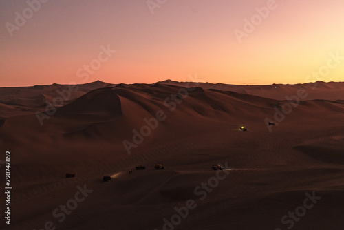 sunset over the dunes around huacachina in the Peruvian desert