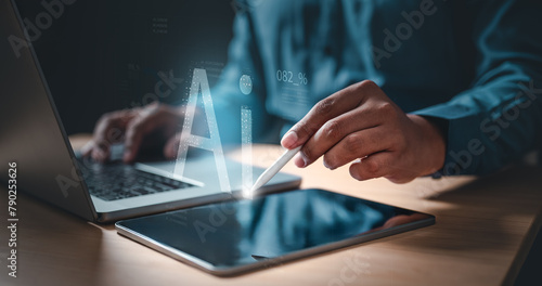 ai, future, artificial, intelligence, marketing, strategy, information, financial, network, innovation. A person is using a tablet to type on a laptop. holding a stylus on a tablet, and the word AI. © Day Of Victory Stu.