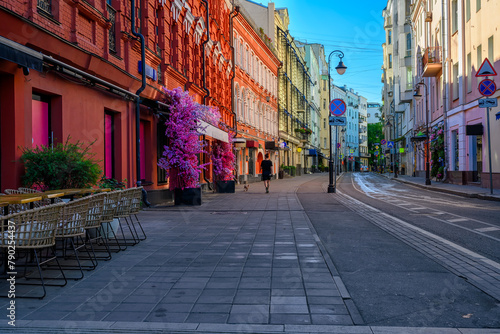Street with tables of cafe in center of Moscow in Russia. Cozy cityscape in Moscow. Architecture and landmarks of Moscow.