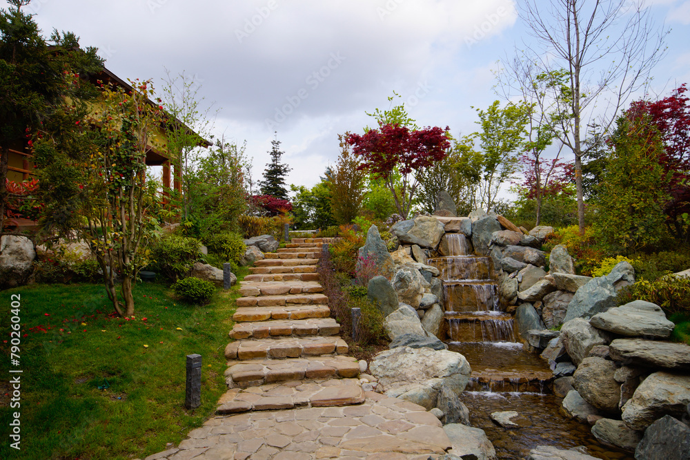 A beautiful Japanese garden with a pond and Tahoto Pagoda in the distance. Japanese garden in the public park of the city of Krasnodar, Russia.