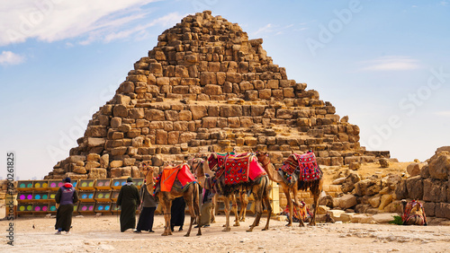Camels dressed up finery wait for tourists in front of the Pyramid of Hetepheres, one of the queen's pyramid on the Giza plateau  photo