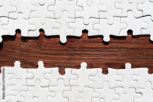 Jigsaw Puzzle with Missing Pieces Revealing Wooden Background
