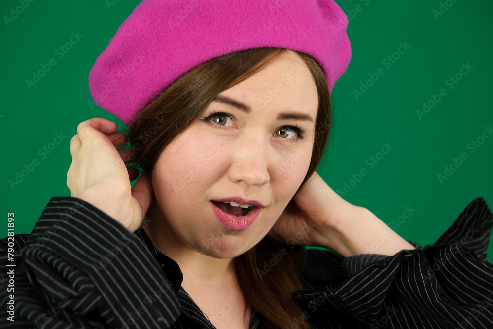 woman on a green background chromakey in a black striped mens shirt different emotions facial expression close-up advertising space for text clean. kind eyes. Portrait of young french style woman woman on a green background chromakey in a black striped mens shirt different emotions facial expression close-up advertising space for text clean. kind eyes. Portrait of young french style woman
