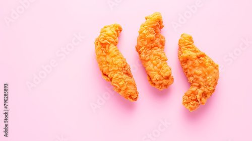 Breaded chicken tenders, Golden fried chicken strips, close-up, simple soft pink background