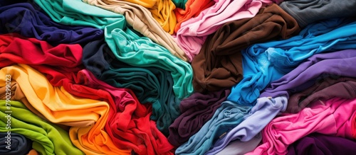 Lots of bright messy colorful clothes. photo