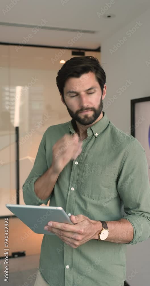 Serious financial analyst using digital tablet device in office, check e-mail, responding to client queries, make data research, review stock markets trends using modern business analytics application Serious financial analyst using digital tablet device in office, check e-mail, responding to client queries, make data research, review stock markets trends using modern business analytics application
