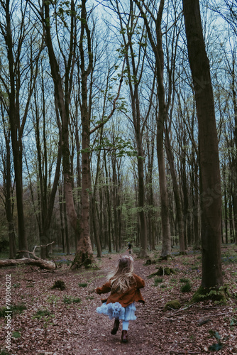 A little girl running in the woods