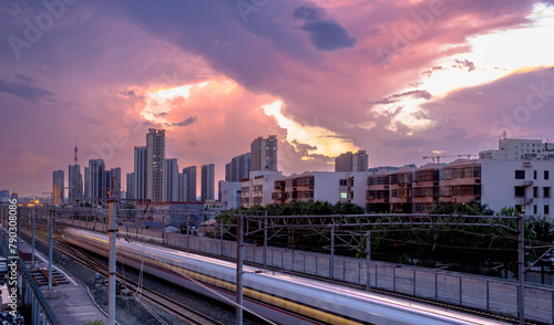 the train passing the city with dramatic clouds in the background