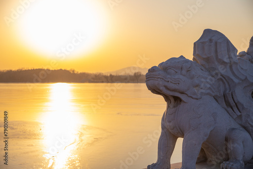Chinese stone lions with sunset in the  Summer Palace, Beijing, China photo