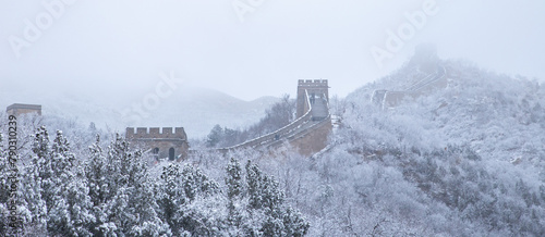 Panoramic view of the Badaling Great Wall with snow covered forest and fog in winter, Beijing, China