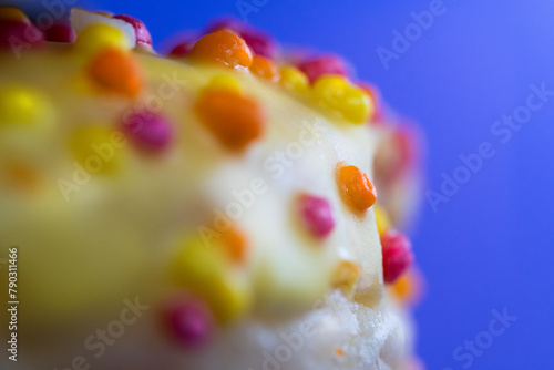 Colorful icing cookie elements. Donut on pastel background. Macro photography.