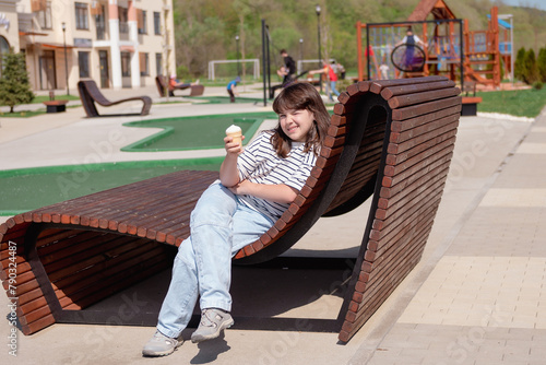 portrait of a happy smiling girl 11 years old with ice cream playing on a children's playground.looks at the camera close-up. High quality photo