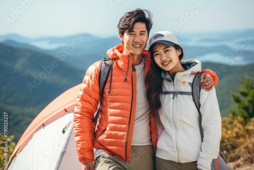 beautiful happy korean couple enjoying summer hiking outdoor camping alpin mountain view daylight  photo