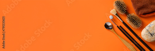 Reflexology tools web banner. Various implements used in reflexology therapy isolated on orange background with copy space. photo