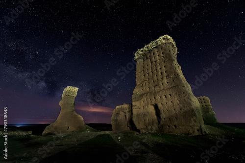 night view of the ruins of the Palenzuela castle, in Palencia, with the starry sky and the milky way photo