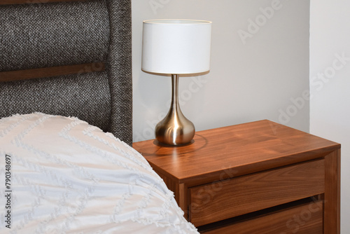 Картината върху платно Nightstand next to the bed with lamp