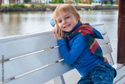 Portrait of a happy little boy on a bench