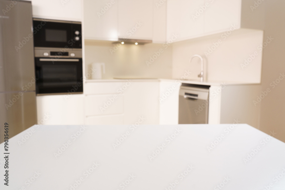 white table on the background of a white kitchen, background for placing a product on it white table on the background of a white kitchen, background for placing a product on it