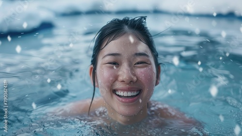 Happy young woman in the water - A joyful young Asian woman smiling as she enjoys her time in the water