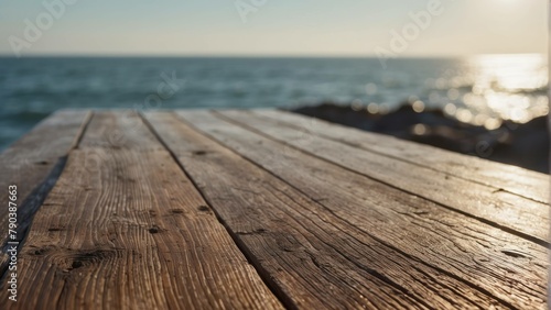 Sun setting or rising over the ocean viewed from a wooden table