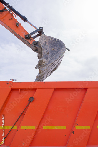 construction theme, excavator bucket and Kamaz body close up. High quality photo