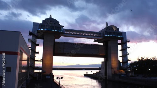 NUMAZU, SHIZUOKA, JAPAN - MAR 2024 : View of VIEW-O flood gate at Numazu Port. Gigantic gate designed to protect the city from tsunami. One of the largest water gates in Japan. Sunset time lapse shot. photo